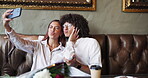 Selfie, pout and couple in restaurant for bonding, romance or anniversary celebration together. Photograph, smile and love with man, woman and flowers for valentines day date for social media