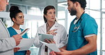 Doctors, group and discussion with documents in hallway with leader, report and tablet for medical solution. People, men and women with paperwork, touchscreen and planning for surgery at hospital