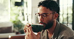 Home, couch and man with warm coffee to drink, espresso and comfortable on weekend in living room. House, male person and blow in morning for hot cappuccino, beverage and relax with caffeine on sofa
