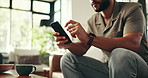 Search, phone and typing with hands of man on sofa for social media, streaming or online update. Networking app, conversation and post with closeup of person in living room at home for chat on mobile