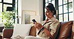 Smile, phone and typing with woman on sofa for social media, streaming or online update. Networking app, conversation and post with person and mobile in living room at home for chat and contact