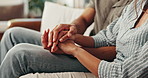 Couple, holding hands and closeup on sofa in home for love, care and bonding with marriage in living room. People, trust and loyalty with partnership, embrace and support in relationship at house