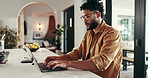 Laptop, writing budget and man with notebook, checklist and budget in home for planning bills. Financial, documents and person bookkeeping for accounting audit, investment growth or income report