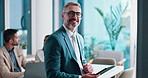 Businessman, typing and face in office with tablet for company proposal evaluation or funding review. Mature budget analyst, coworking or brainstorming digital report for agreement or presentation