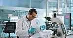 Microscope, chemical and man scientist with pipette in laboratory for research, study or project. Biotechnology, liquid and biologist work on pharmaceutical innovation with glass beaker for medical.