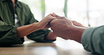 Comfort, holding hands or stress and people in home together with support for grief, loss or pain. Anxiety, love and trust with friends closeup at table in apartment for compassion, help or patience