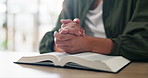 Praying, hands and man with bible in house for religion study, worship or spiritual journey. Hope, gratitude and male person with scripture for peace, faith or guidance prayer in living room at home.