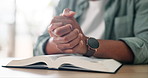 Praying, hands and man with bible in apartment for religion study, worship or spiritual journey. Hope, gratitude and male person with scripture for peace, faith or guidance prayer in living room.
