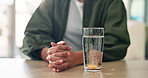 Hands, health and effervescent pills in water for wellness or medical painkiller in home. Medicine, person and dissolve drugs in glass closeup for prescription treatment, supplements or fizzy bubbles