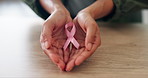 Pink ribbon, hands and woman at desk breast cancer, healthcare and care. Support, community help and movement icon with disease prevention, person and recognition with empathy, charity and awareness