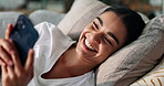 Dating app, laughing and phone with woman on sofa in living room of home for communication. Funny, relax and social media with happy person in apartment for connection, notification or online chat
