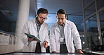 Scientist, talking and teamwork with tablet in laboratory for pharmaceutical review, medical research or innovation. Night, people and interactive display for studying science, meeting and results