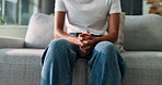 Hands, mental health and person on sofa with anxiety, stress or emotions in living room at home. Nervous, worry and leg shake for panic attack with phobia, overthinking or fear of trauma in house.