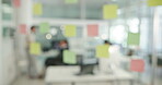 Glass, planning and blur with business people in office for problem solving, idea and meeting. Brainstorming, sticky notes and moodboard with employees in agency for solution, idea and project