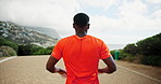 Warm up, runner and back of man in nature for marathon race, exercise and health. Workout, wellness and cardio with person training at park for sports athlete, challenge and fitness stretching
