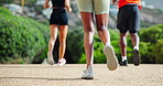 Sneakers, running and people with fitness, nature and cardio with exercise, dirt road and workout. Closeup, group and runners with training, shoes and practice with wellness and stamina endurance
