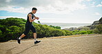 Smart watch, running and health with man in nature for marathon timer, exercise and tracking. Workout, wellness and cardio with person training at park for sports athlete, challenge and fitness