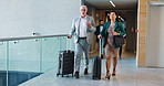 Airport, suitcase and business people with conversation, walking and global trade. Employees, import expert and coworkers with international travel, discussion and planning for export growth or talk