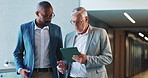 Tablet, walking and business men in conversation, planning or help with investment project in office. Technology, team collaboration or discussion for financial news, training or coaching with mentor