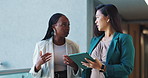 Tablet, walking and business women in conversation, planning or help with investment in office. Technology, team collaboration and discussion for financial news, economy or brainstorming solution