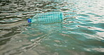 Water pollution, trash and plastic bottle litter at beach for poor waste management or illegal garbage disposal. Nature, rubbish and floating in ocean for recycling fail, mess or environmental hazard
