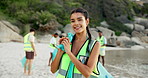 Face, beach cleanup and woman with trash bag, ecology and sustainability with climate change. Portrait, person and activist with plastic collection, eco friendly or seaside with environment and smile