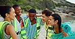 Huddle, jump and rubbish with friends on beach for cleaning, conservation or environmental activism. Charity, energy and recycling with group of happy people on coast for achievement or success
