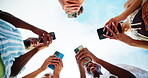 Outdoor, group and friends with hands for smartphone, typing and connection for social media in below. Blue sky, people and network with mobile for application, digital and technology in low angle