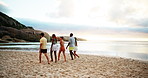 Beach, back view and friends walking on vacation, adventure and bonding together on tropical island. People, sea and group on trip outdoor at ocean for summer holiday, travel and wind at sunset