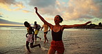 Freedom, sunset and friends running on ocean water for adventure, excited or celebration with energy. Happy people, sea race or group on trip outdoor at beach for summer vacation, travel and holiday