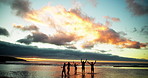 Shadow, friends and people on beach at sunset for holiday, vacation and weekend together. Nature, horizon and back of men and women in ocean, sea and waves for adventure, freedom and travel outdoors
