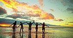 Sunset, holding hands and beach with friends, running and travel with vacation, cardio or tropic island. Water, ocean or men with women, people or summer holiday with weekend break, relax or Zanzibar