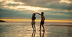 Dance, beach and couple at sunset for love on holiday, vacation and weekend in nature. Travel, dating and man with woman by ocean for romance, bonding and relationship for adventure, relax and fun