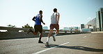 Men, friends and running on bridge for exercise with training for marathon, competition or race in city. Athlete, back and together for workout, challenge and fast for fitness on urban road in summer