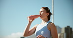 Girl, runner and drinking water in city on break, fitness and outdoor with hydration for wellness in summer. Woman, bottle and liquid for workout, exercise and training for marathon in Cape Town