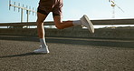 Running, fitness and legs of person in city for workout, marathon training and exercise. Sports, endurance and athlete on street with movement for challenge, health and performance for race outdoors
