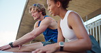 Fitness, stretching legs and couple in city for workout or body health in low angle. Warm up muscle, athlete and getting ready to exercise outdoor, training and interracial people talk by bridge
