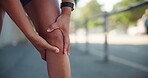 Fitness, athlete and hands with knee pain outdoor with joint ache, running accident and sports injury. Runner, person and exercise mistake with leg tension, inflammation and muscle sprain on sidewalk