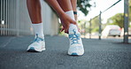Runner, hands and ankle pain on street with injury, fatigue and sprain with inflammation in city. Person, athlete and outdoor for fitness, workout and exercise with joint ache and stress on sidewalk