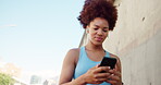 Outdoor, woman and fitness with mobile for music, walking or streaming app for audio track. African female person, runner or earphones with smartphone for sound, exercise or listen to hip hop in city