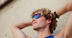 Runner, fitness or man with resting outdoor for exercise break, breathing or running recovery. Low angle, sport or relax with sunglasses for cardio challenge, marathon training or workout performance