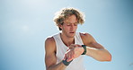 Outdoor, tired and man with smart watch, fitness and challenge with fatigue, blue sky and exercise. Healthy person, model or runner with training, check time or progress with space, break or wellness