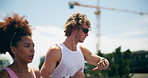 Interracial couple, watch and running for workout, exercise or fitness goals together in urban town. Man, woman and training with cardio, sports or marathon for endurance and health or wellness