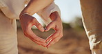 Heart hands, outdoor and couple with nature, support and bonding together with kindness. Closeup, people and man with woman, symbol for love and romance with relationship, countryside and commitment