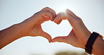 Heart hands, outdoor and couple with support, romance and bonding together with kindness. Closeup, people and man with woman, symbol for love and trust with relationship, affection and commitment