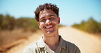 Face, happy and man with travel in nature for safari adventure, confident tourist and holiday destination. Laughing, person and smile in desert road for vacation getaway, sightseeing and exploring