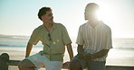 Beach, friends and men with vacation, conversation and relax with weekend break. People, seaside and guy with summer holiday, seaside and bonding together with smile, lens flare and discussion