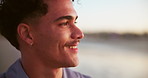 Man, smile and sunset at ocean with thinking, relax and fresh air with travel. Person, happy and face at beach with peace, vacation break and deep breath for mindfulness with space at seaside