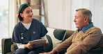 Home, old man and nurse with clipboard, conversation and routine checkup with symptoms. Mature patient, medical and professional on sofa, documents and healthcare with consultation, report or support