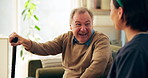 Caregiver, home and laughing with senior man for funny joke, help and support. Medical, happy nurse and talking to patient with disability, cane or rehabilitation for geriatric healthcare or wellness